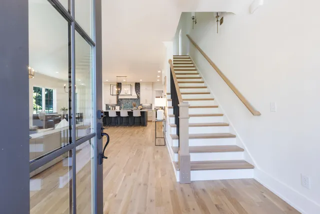 a view of a room with wooden floor and stairs