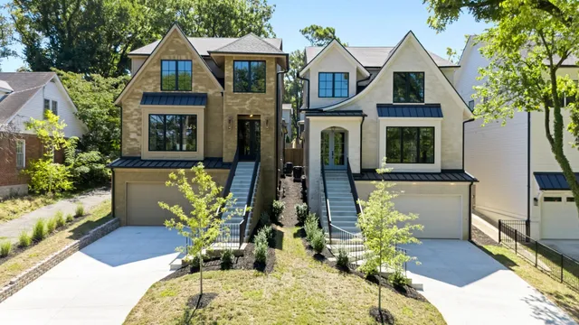 an aerial view of a house with a yard and lake view