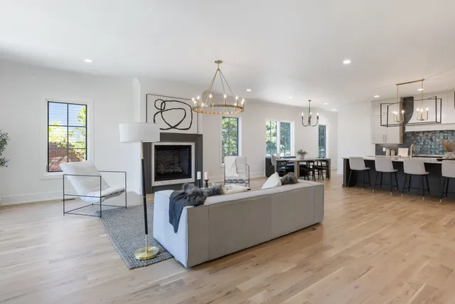 a living room with furniture a fireplace and a large window