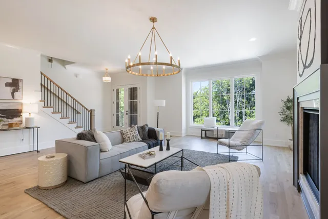 a living room with furniture a table and wooden floor