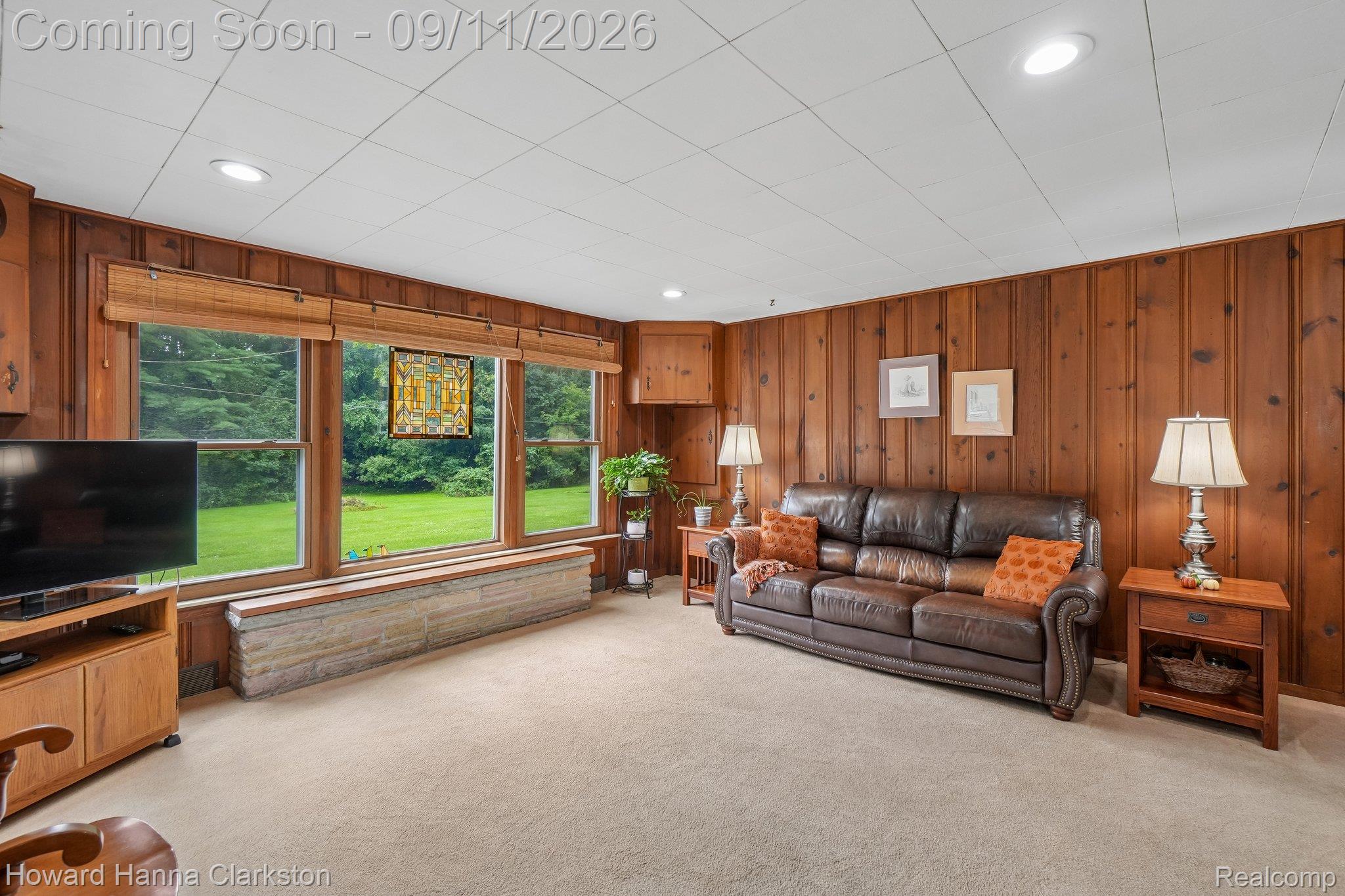 8301 Foster Road Clarkston, MI 48346 - Photo 9 of 41 Knotty pine paneled walls, large windows, recessed lighting, and a stone-clad window seat