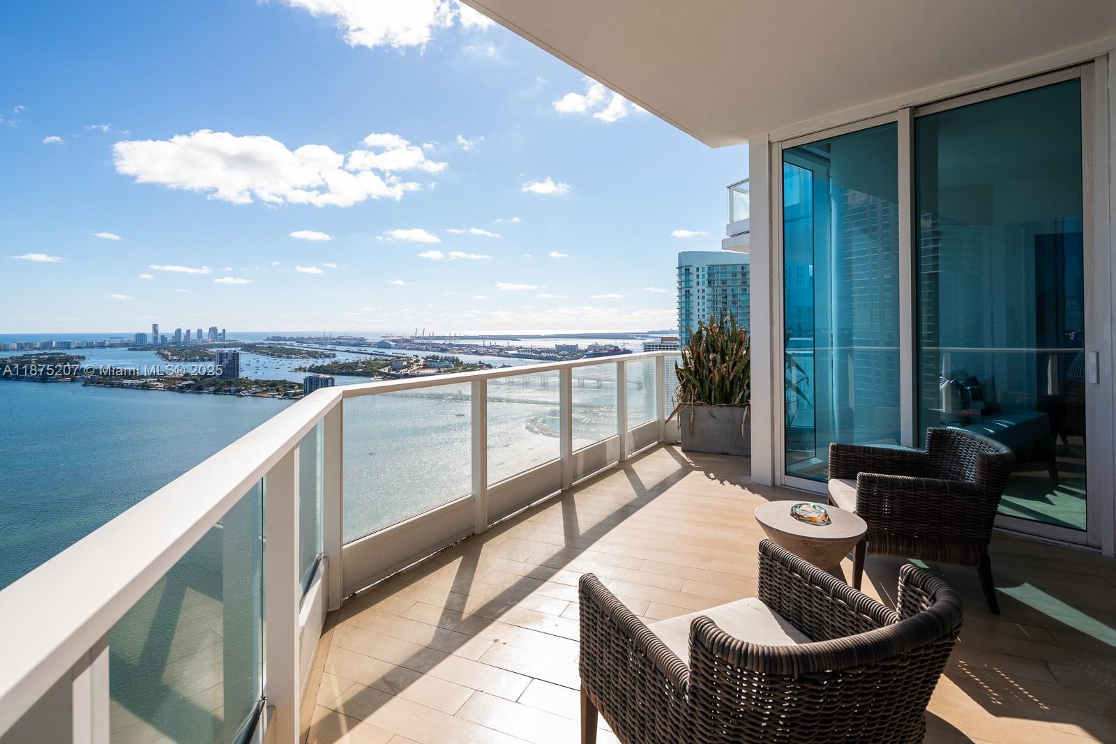 2020 North Bayshore Drive, Unit 4101 Miami, FL 33137 - Photo 11 of 23 a balcony with table and chairs