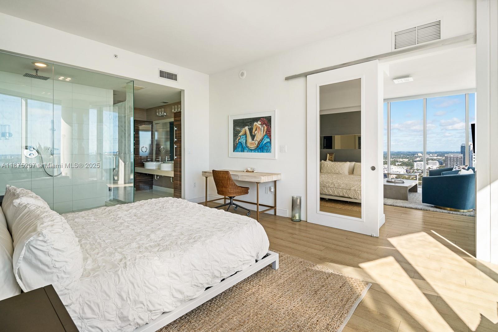 2020 North Bayshore Drive, Unit 4101 Miami, FL 33137 - Photo 16 of 23 a spacious bedroom with a bed and glass table