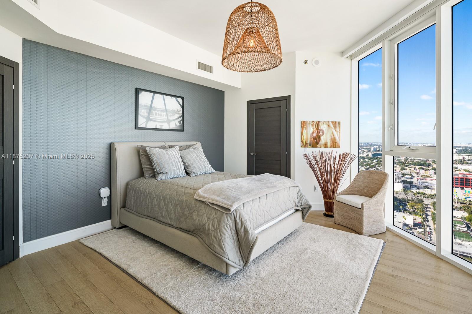 2020 North Bayshore Drive, Unit 4101 Miami, FL 33137 - Photo 19 of 23 a bedroom with a bed and a chandelier