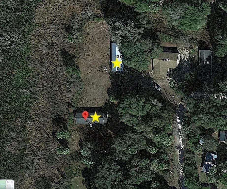 15098 Northeast 35th Avenue Road Citra, FL 32113 - Photo 10 of 11 a backyard of a house with lots of green space