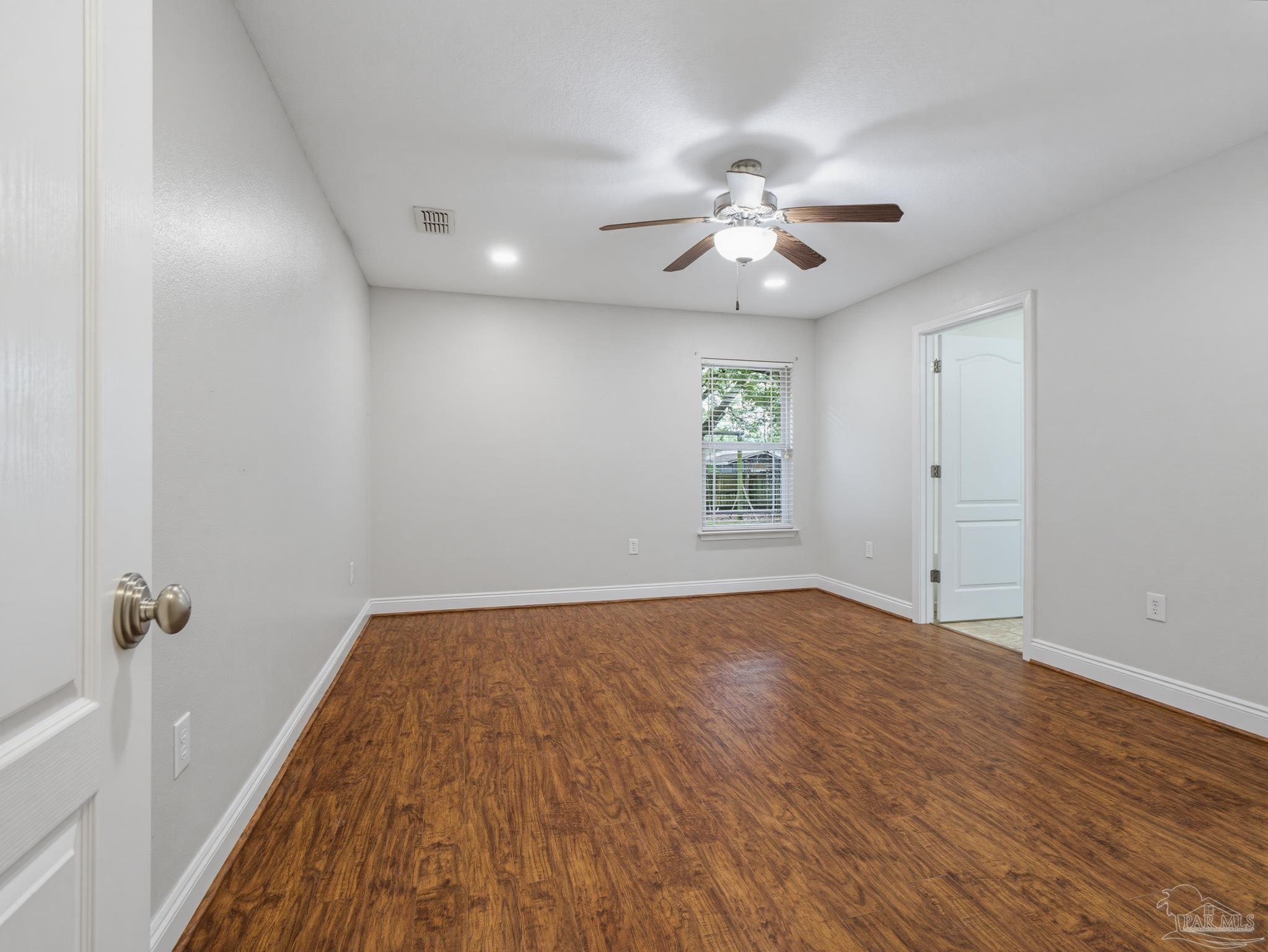 5567 Jones Street Milton, FL 32570 - Photo 25 of 48 wooden floor in an empty room with a window