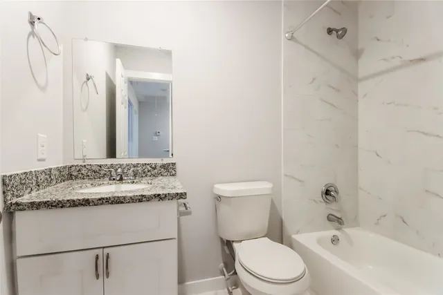a bathroom with a sink toilet vanity and shower