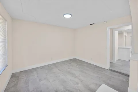 an empty room with windows and entrance