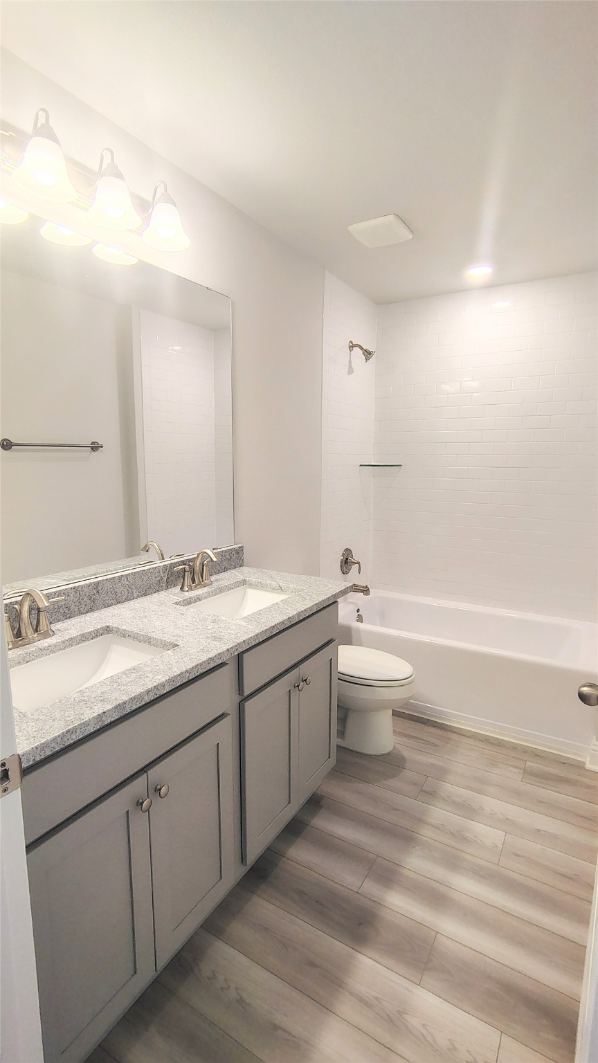 5 Keystone Court Angleton, TX 77515 - Photo 16 of 18 a bathroom with a granite countertop sink mirror and toilet