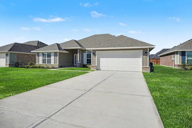 a front view of house with yard and green space