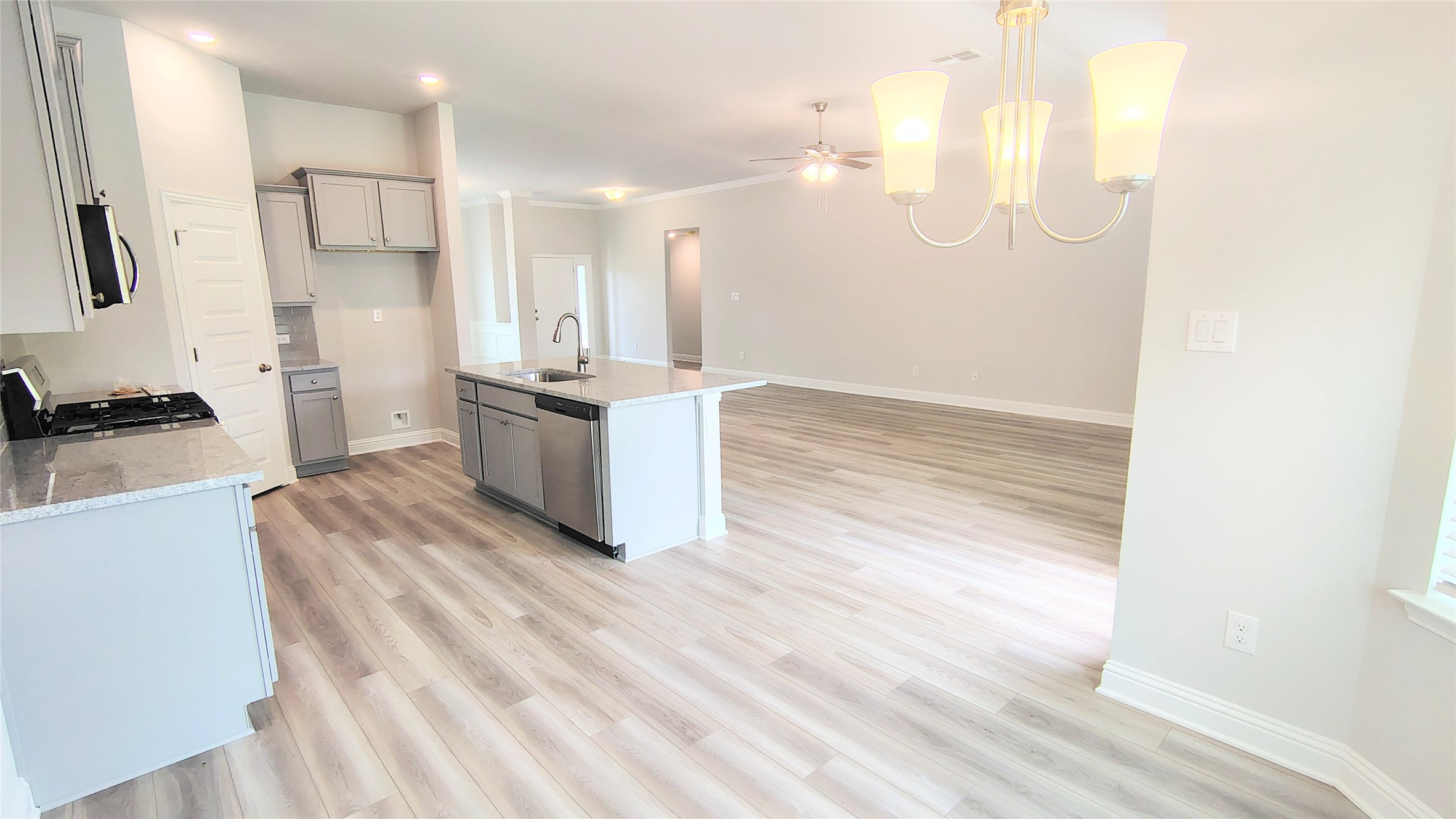 5 Keystone Court Angleton, TX 77515 - Photo 6 of 18 a large white kitchen with kitchen island a sink stainless steel appliances and cabinets