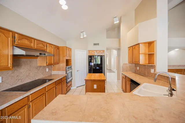 a view of an empty room with window cabinet and fire place