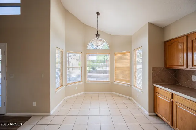 a large kitchen with a large window and a sink