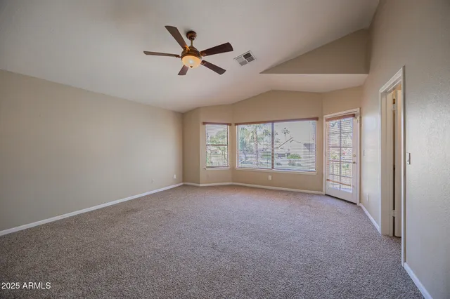 a view of a livingroom with a ceiling fan and window