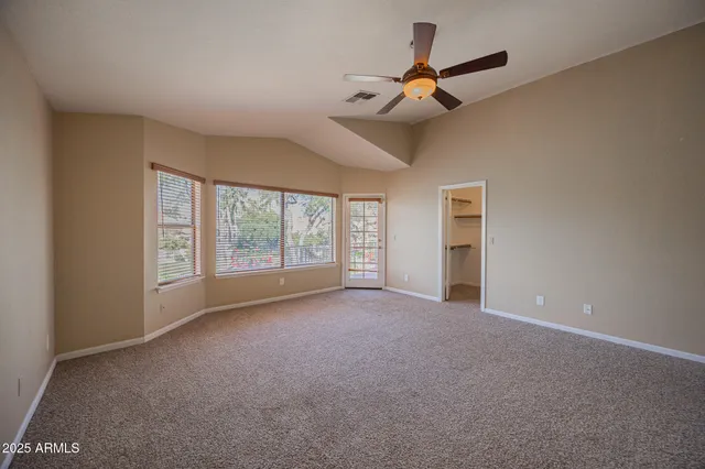 a view of a room with a ceiling fan