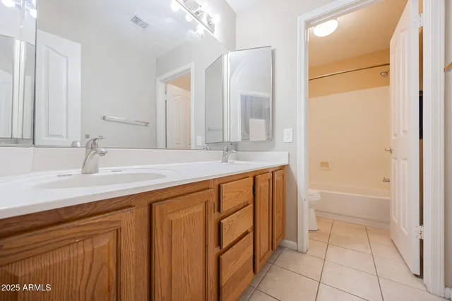 a white toilet sitting next to a bath tub