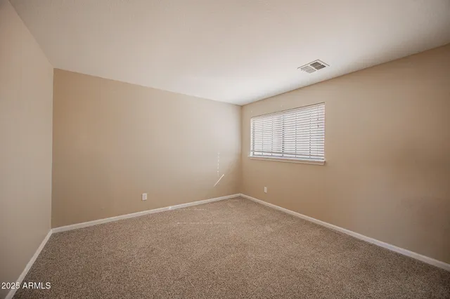 a view of an empty room and closet area