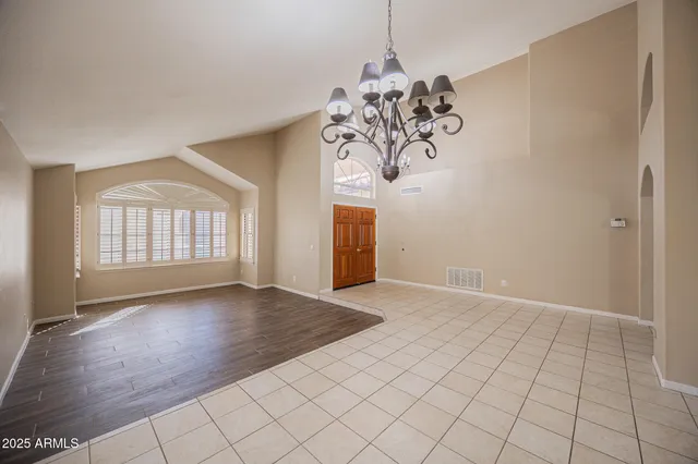 a view of a livingroom with wooden floor and a ceiling fan