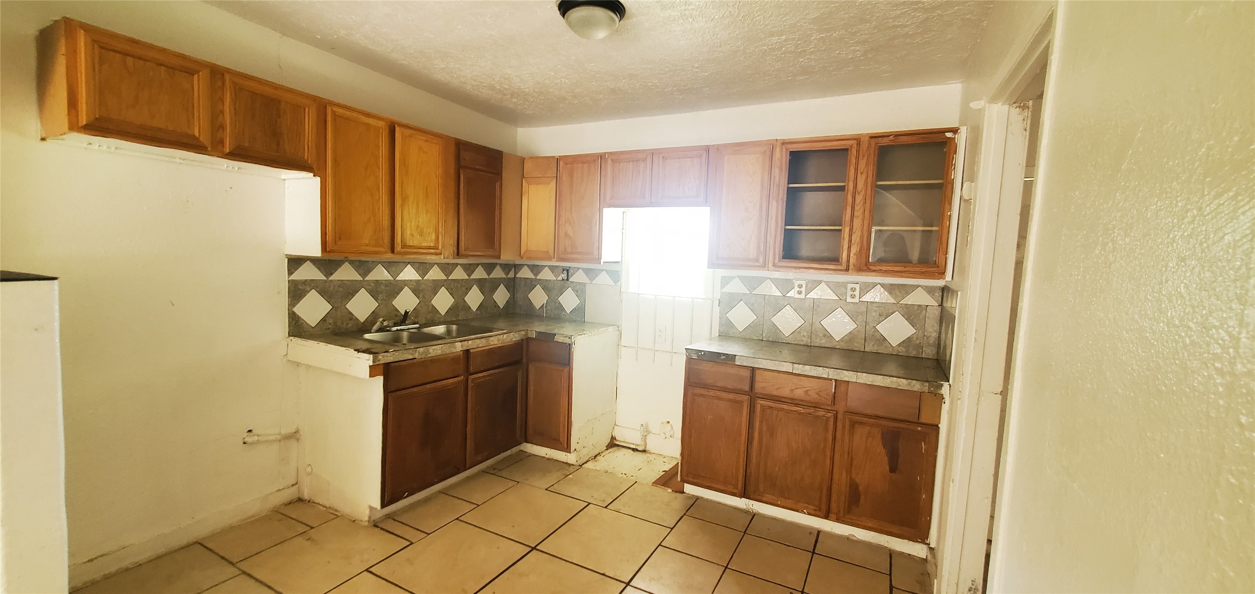 5238 Pershing Street Houston, TX 77033 - Photo 3 of 13 a kitchen with granite countertop a sink and a stove