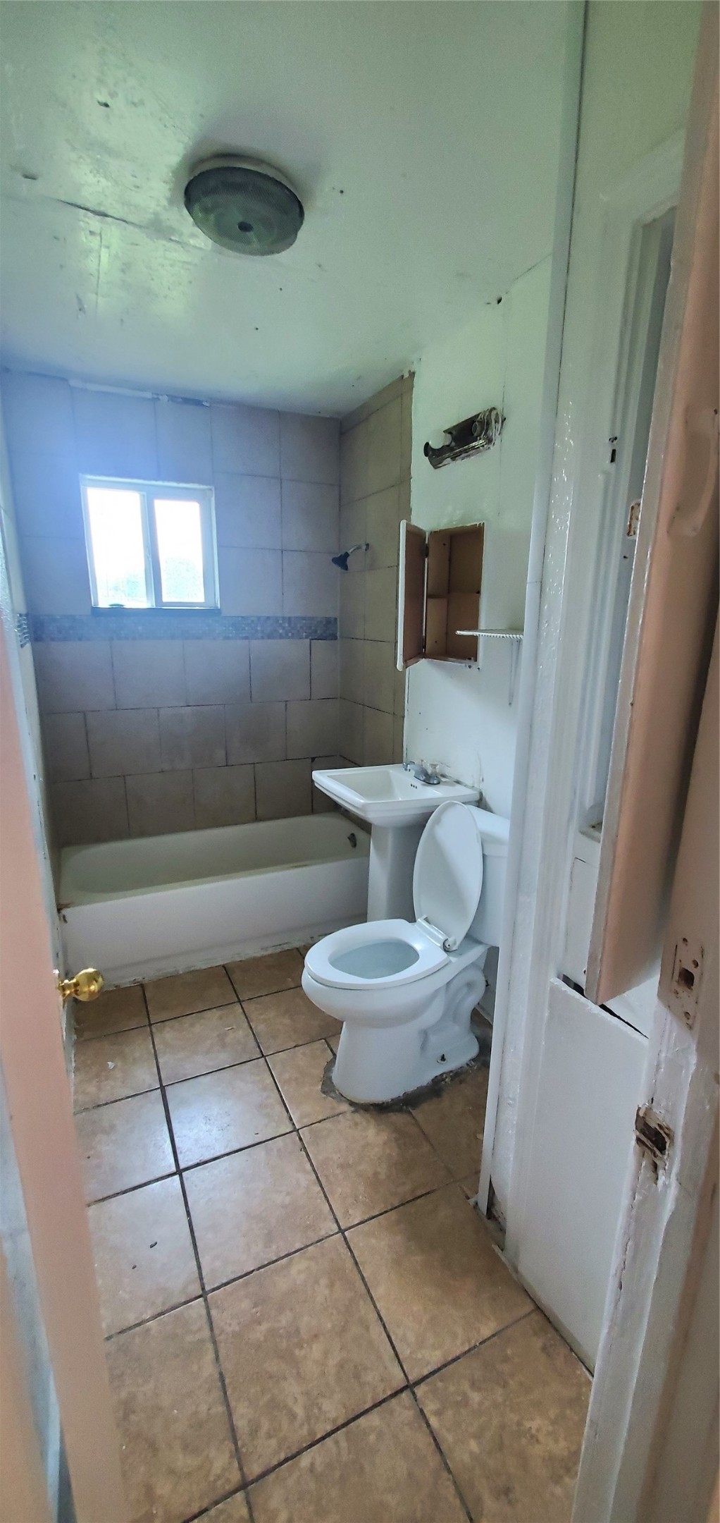 5238 Pershing Street Houston, TX 77033 - Photo 6 of 13 a bathroom with a toilet and a mirror