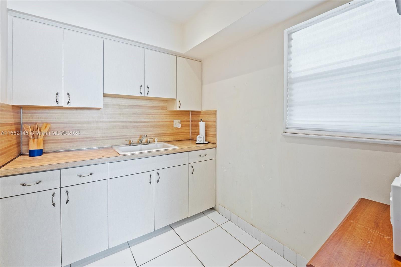 6501 Winfield Boulevard, Unit A31 Margate, FL 33063 - Photo 14 of 25 a kitchen with white cabinets