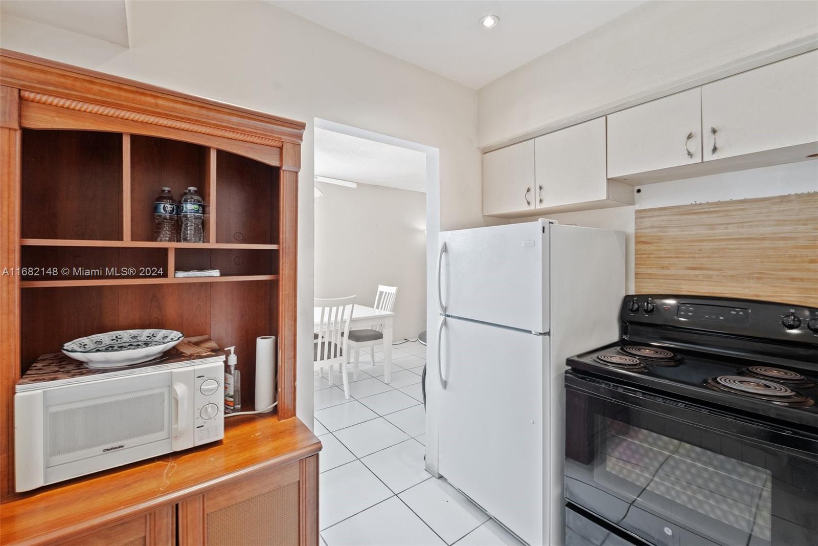 6501 Winfield Boulevard, Unit A31 Margate, FL 33063 - Photo 16 of 25 a white refrigerator freezer and a stove sitting inside of a kitchen