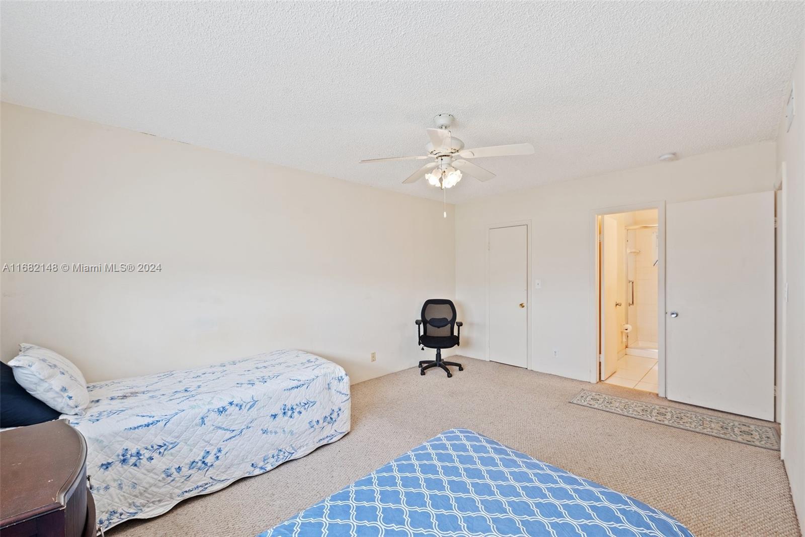 6501 Winfield Boulevard, Unit A31 Margate, FL 33063 - Photo 18 of 25 a bedroom with a bed and a chandelier