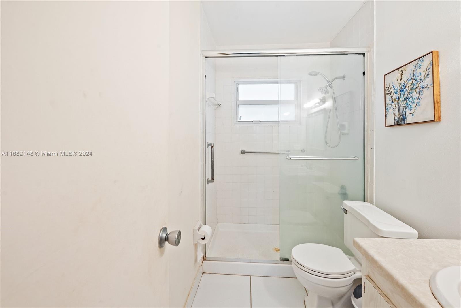 6501 Winfield Boulevard, Unit A31 Margate, FL 33063 - Photo 20 of 25 a white toilet sitting next to a bathroom sink