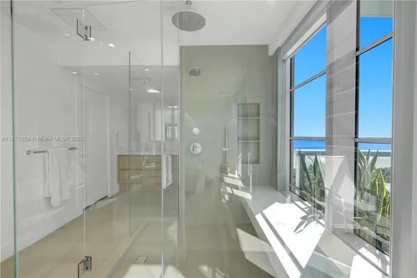 a bathroom with a glass shower door and a bathtub