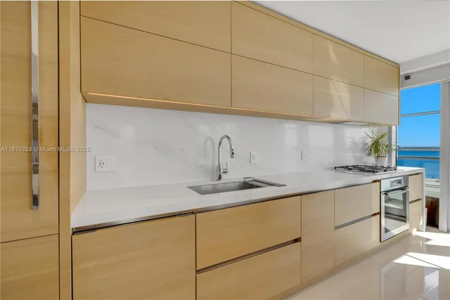 a kitchen with stainless steel appliances granite countertop a sink stove and cabinets