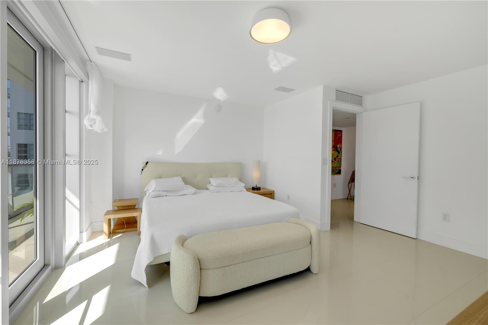 3739 Collins Avenue, Unit N501 Miami Beach, FL 33140 - Photo 9 of 19 a bedroom with a bed and a cabinets