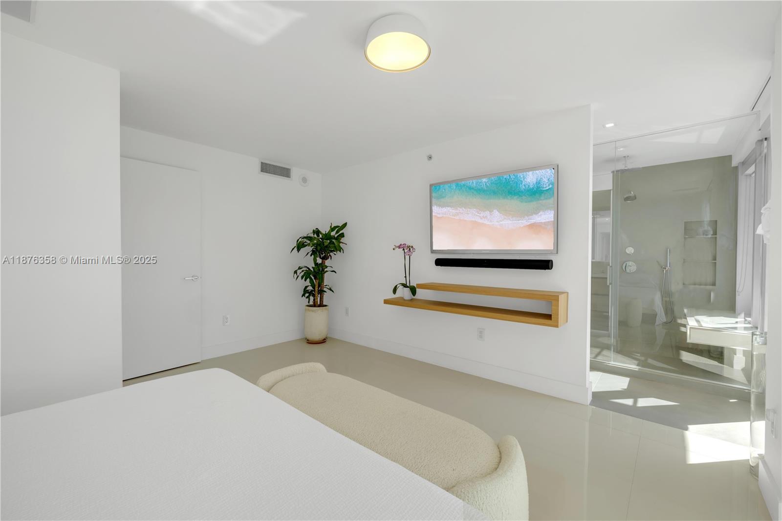 3739 Collins Avenue, Unit N501 Miami Beach, FL 33140 - Photo 10 of 19 a living room with furniture and a flat screen tv