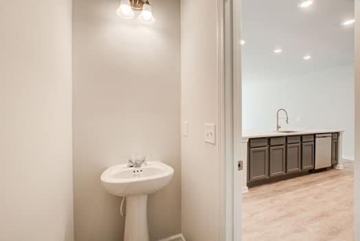 297 Whitetail Circle Canton, GA 30115 - Photo 13 of 35 a bathroom with a sink and a mirror