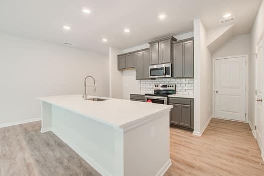 297 Whitetail Circle Canton, GA 30115 - Photo 8 of 35 a kitchen with kitchen island a sink stainless steel appliances and cabinets