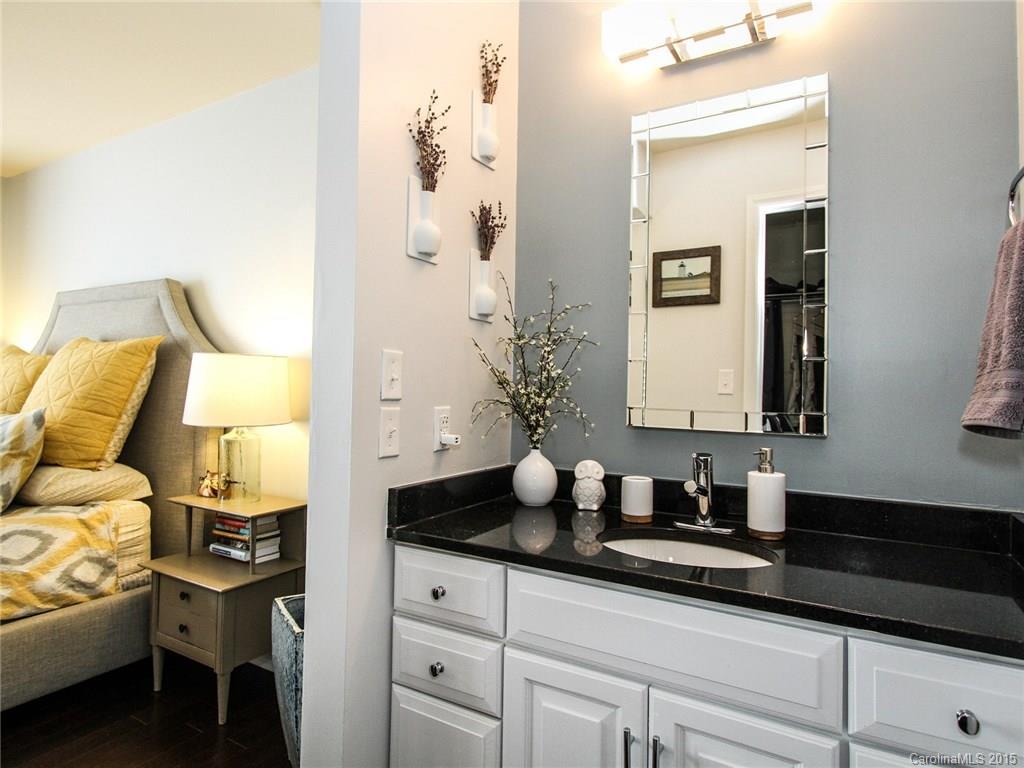 318 Queens Road, Unit 5 Charlotte, NC 28204 - Photo 13 of 24 a bathroom with a granite countertop sink and a mirror
