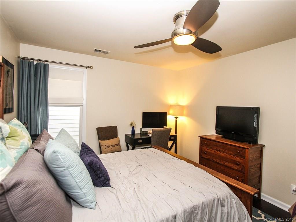 318 Queens Road, Unit 5 Charlotte, NC 28204 - Photo 16 of 24 a bedroom with a bed and a flat tv screen on dresser