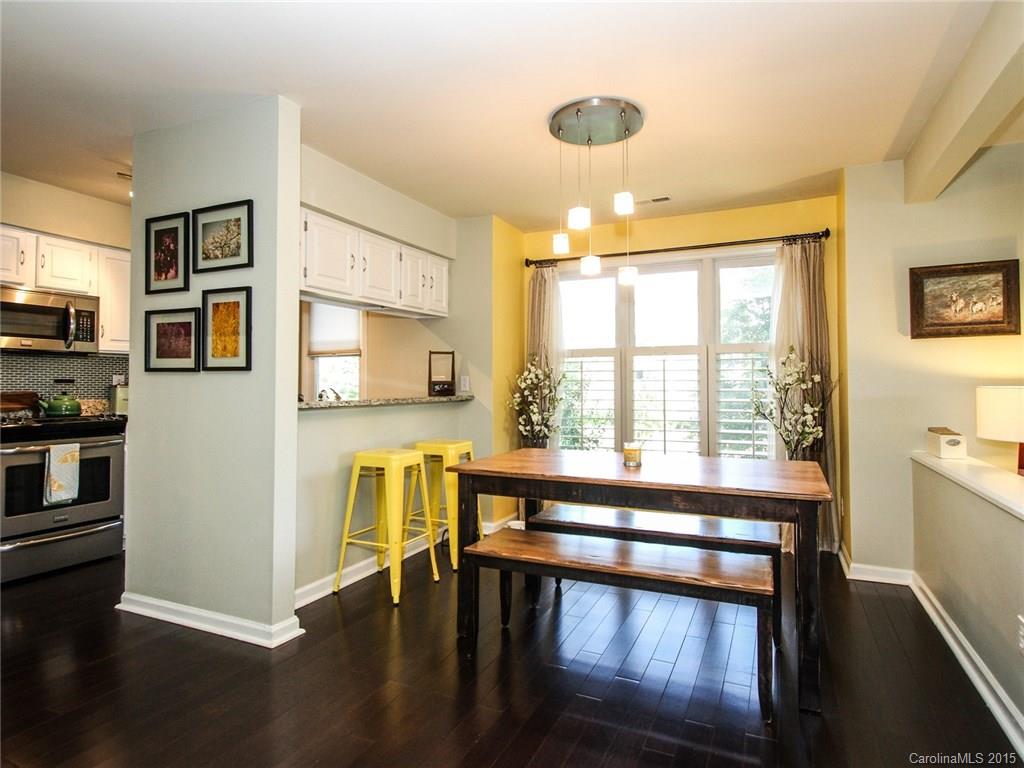 318 Queens Road, Unit 5 Charlotte, NC 28204 - Photo 6 of 24 a view of a kitchen with furniture and large windows