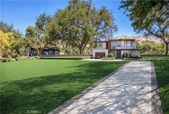 a view of a park with a house in the background