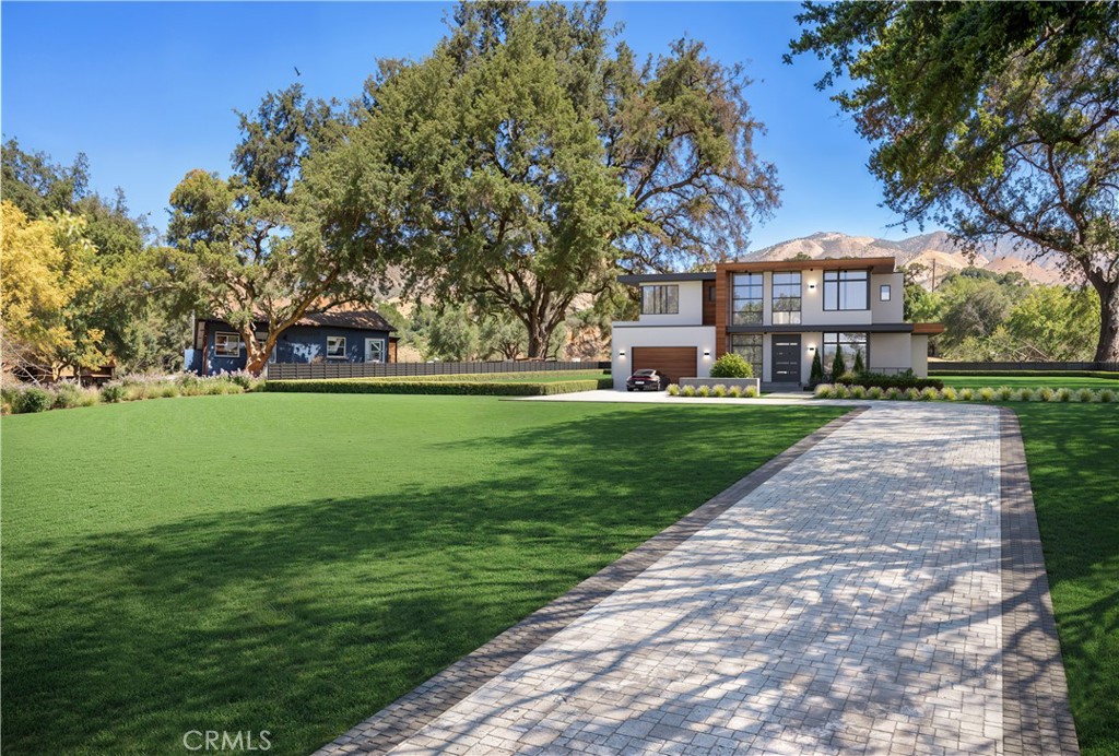 a view of a park with a house in the background
