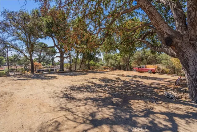 a view of a yard with wooden fence