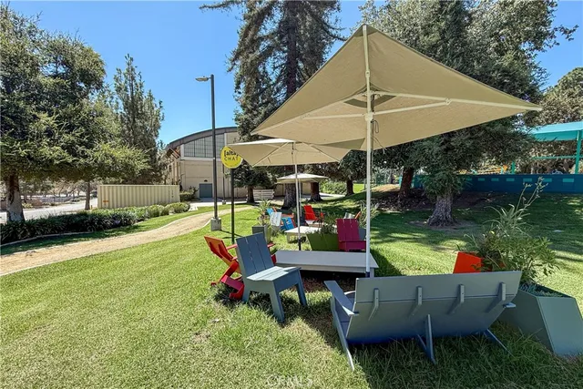 a swimming pool with outdoor seating and yard