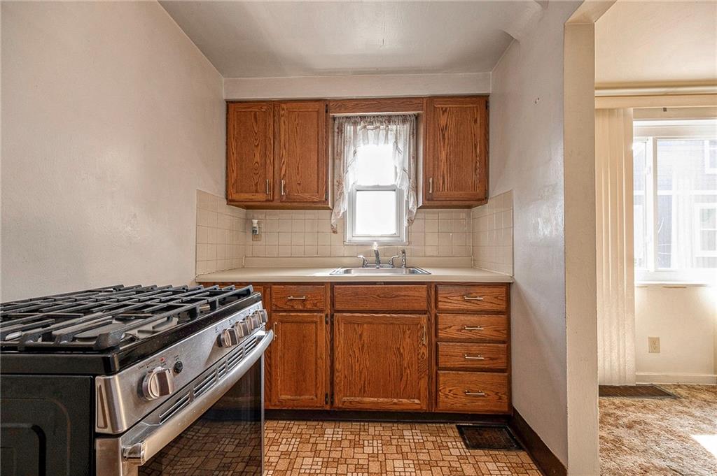 1704 Duffield Street Pittsburgh, PA 15206 - Photo 8 of 32 a kitchen with stainless steel appliances granite countertop a stove and a sink