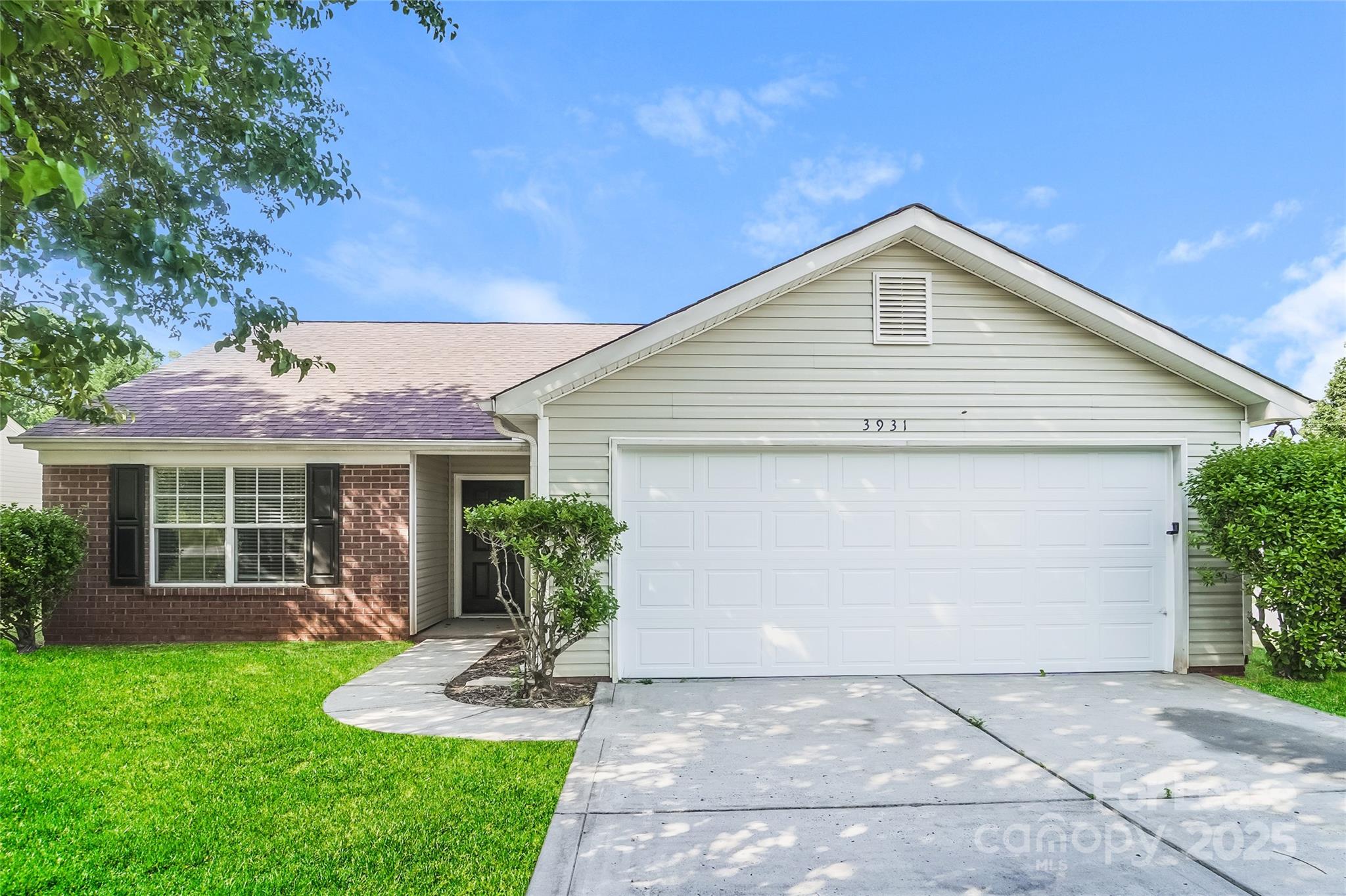 3931 Bitterroot Court Charlotte, NC 28269 - Photo 2 of 16 a front view of a house with a yard and potted plants