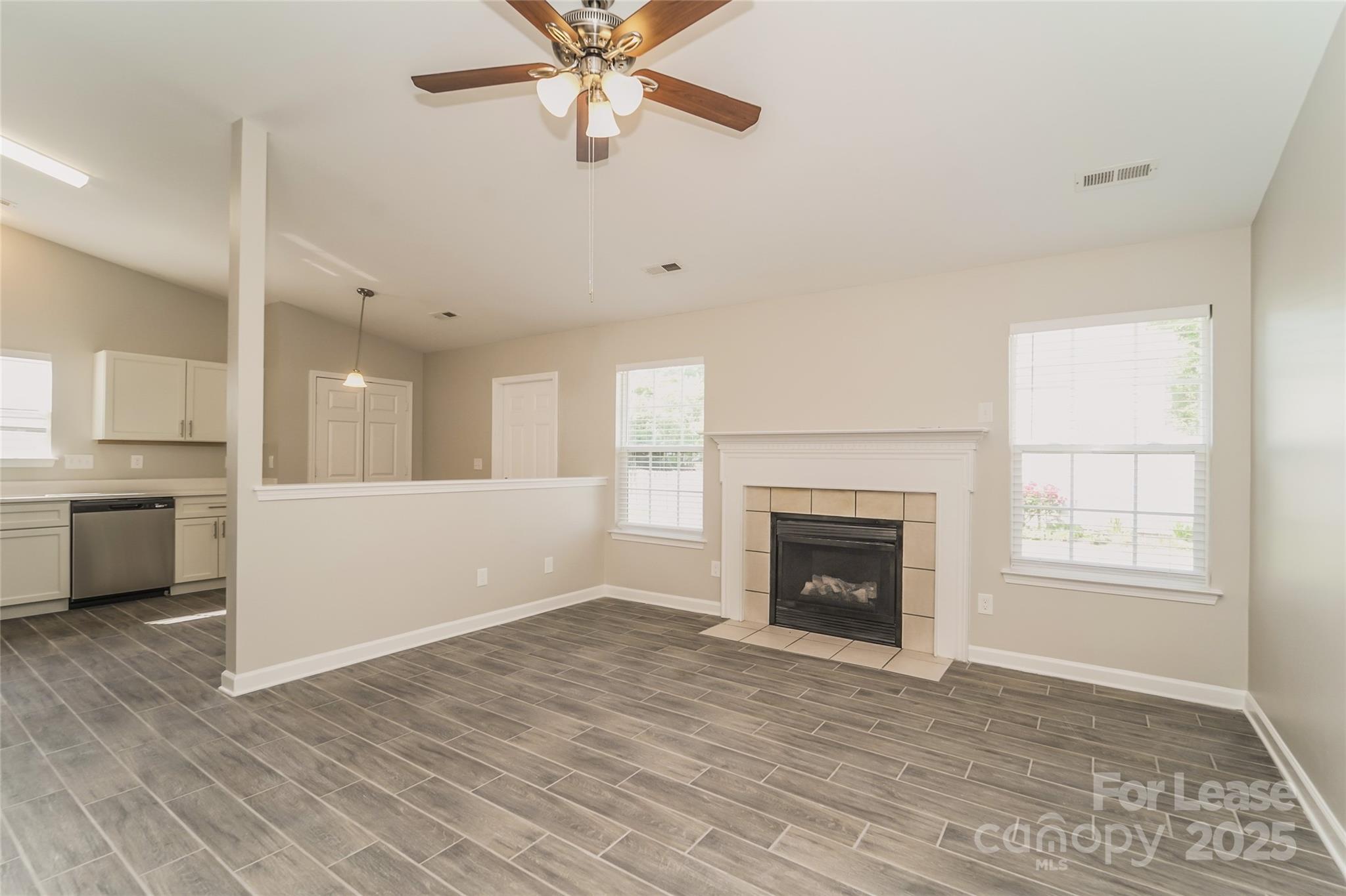 3931 Bitterroot Court Charlotte, NC 28269 - Photo 4 of 16 a view of an empty room with a window and fireplace
