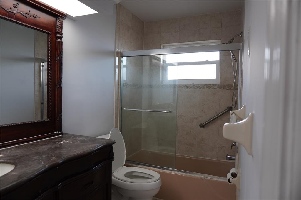 1050 East Sample Road, Unit 104 Pompano Beach, FL 33064 - Photo 11 of 14 a bathroom with a granite countertop sink toilet and shower