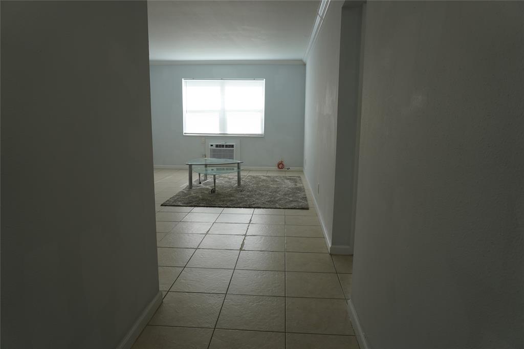 1050 East Sample Road, Unit 104 Pompano Beach, FL 33064 - Photo 3 of 14 a bathroom with a toilet a sink and mirror