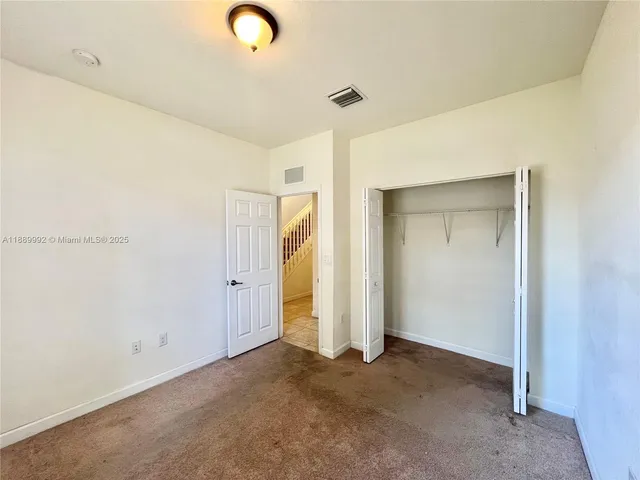 a view of a hallway with a bathroom