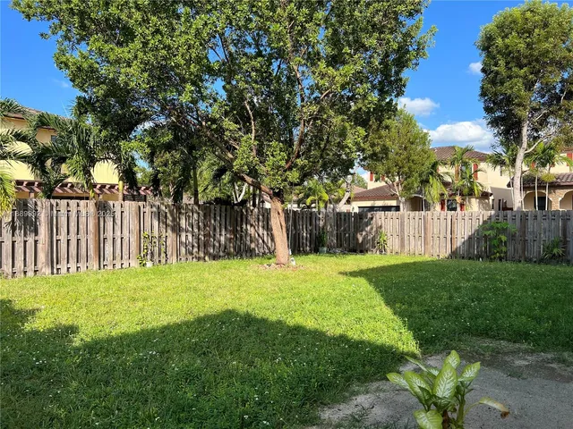 a garden with trees in the background