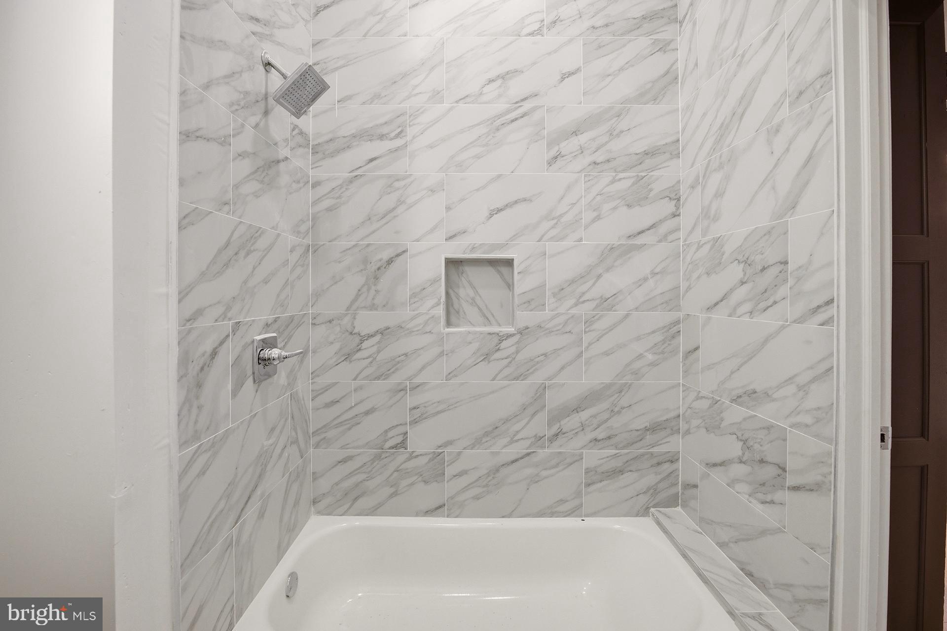6012 Ridge Avenue, Unit 1 Philadelphia, PA 19128 - Photo 11 of 17 a bathroom with a bathtub