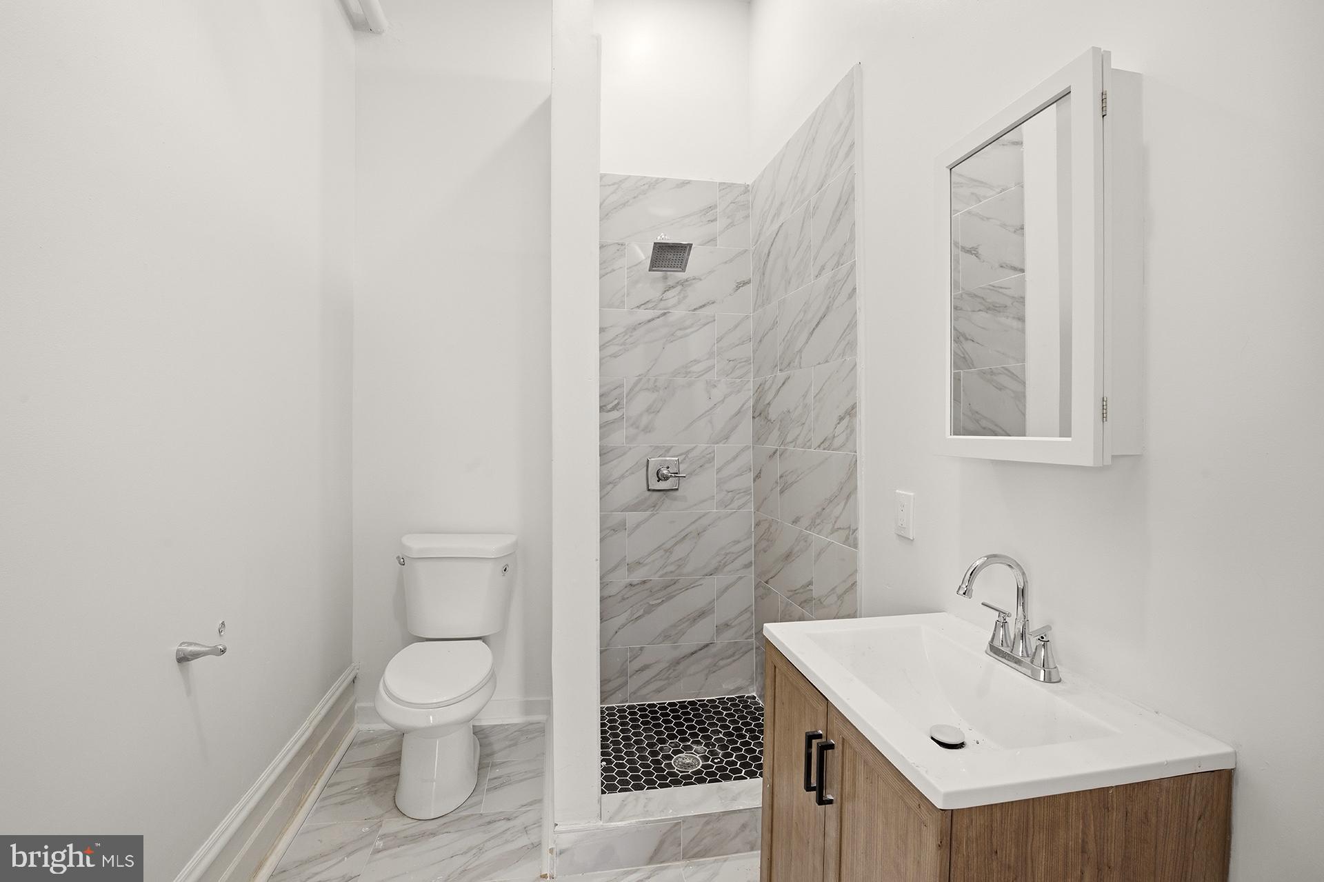 6012 Ridge Avenue, Unit 1 Philadelphia, PA 19128 - Photo 12 of 17 a bathroom with a sink toilet and shower